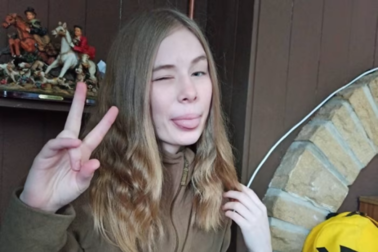 Rhianan Rudd making a playful face and showing a peace sign.