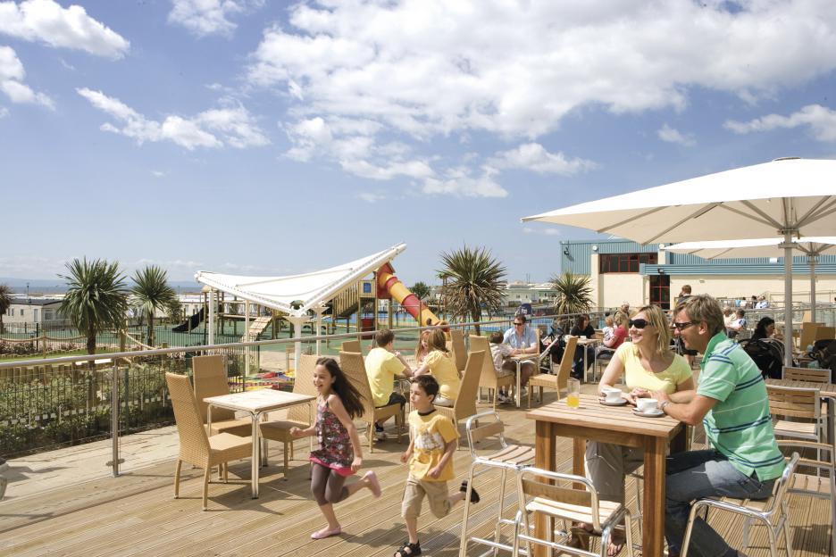 Tourists and children at Trecco Bay Holiday Park caravan site in Wales.