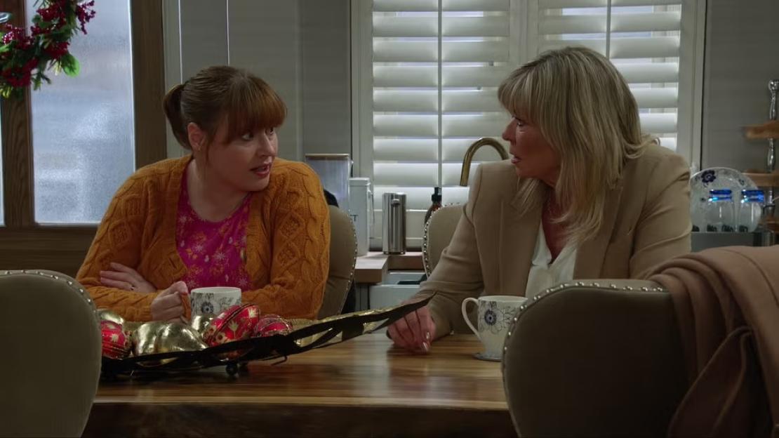 Two women talking at a dining table.