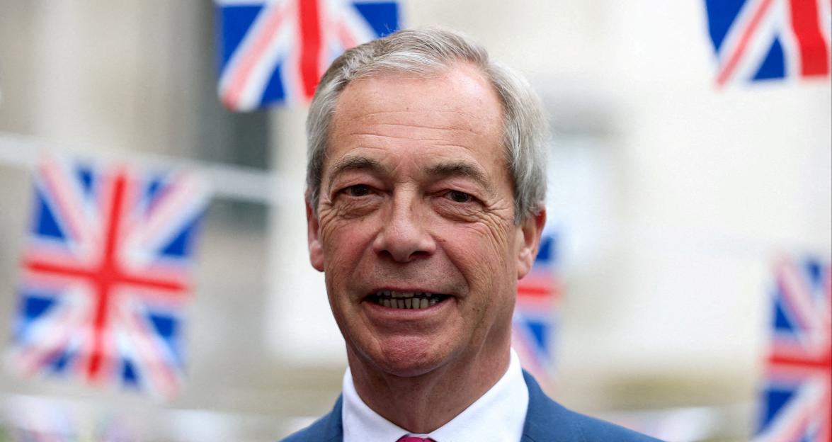 Nigel Farage, leader of the Reform UK party, smiling with Union Jack bunting in the background.