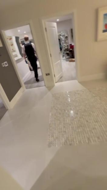 A police officer walking through a house, investigating a burglary.