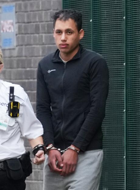 Karin Al-Danasurt, handcuffed, being escorted.