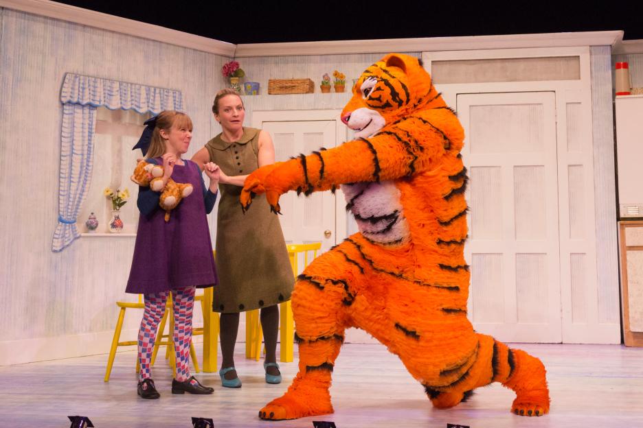 The musical play "The Tiger Who Came to Tea" with characters Sophie, Mummy, and the Tiger in the kitchen set.