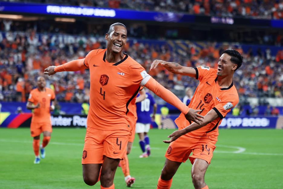 Virgil van Dijk and Tijjani Reijnders celebrating a goal during the 2026 World Cup Group F football match between the Netherlands and Japan.