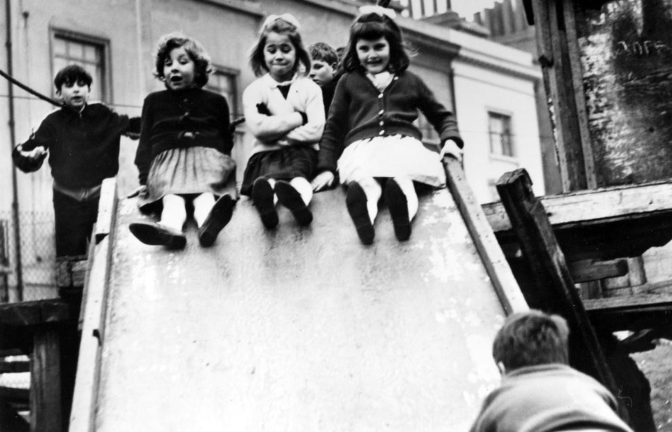 Jackie Bassett, Lynn Johnson, and Susan Davies at age 7 on a playground slide.