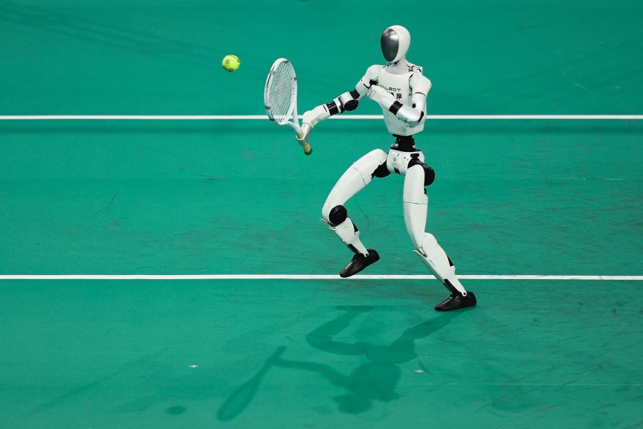 A humanoid robot playing tennis on a green court.