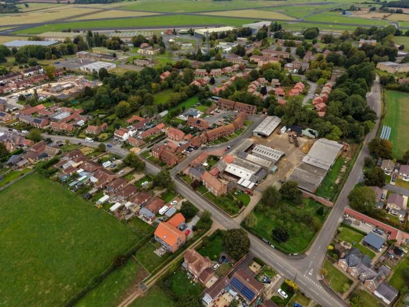 A multi-story brick building behind a security fence at the old RAF base in Linton-on-Ouse.