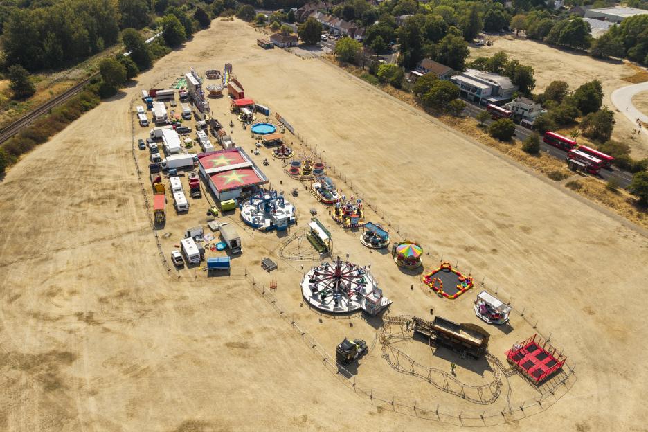 Aerial view of a funfair on parched Commonside West in Mitcham, London.