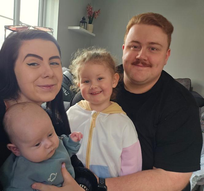 Courtney Sherwood and Tom Dunn hold their children, Penny and Bobby.