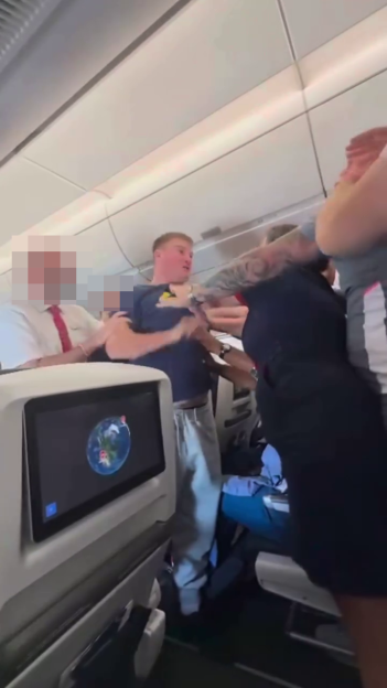 A group of people involved in an altercation on an airplane.