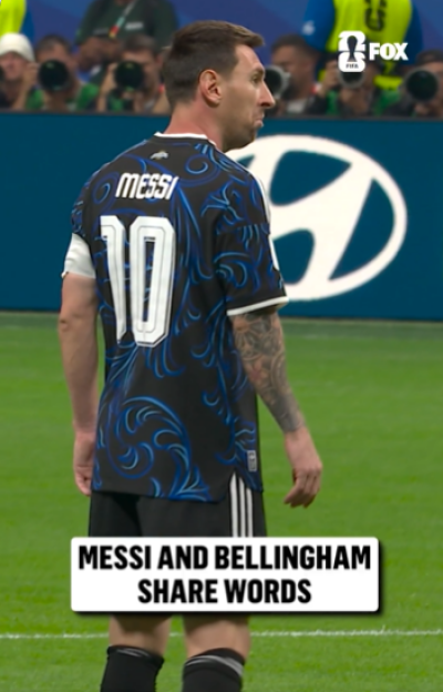 Lionel Messi wearing a blue and black jersey with the number 10, looking to his right on a soccer field.