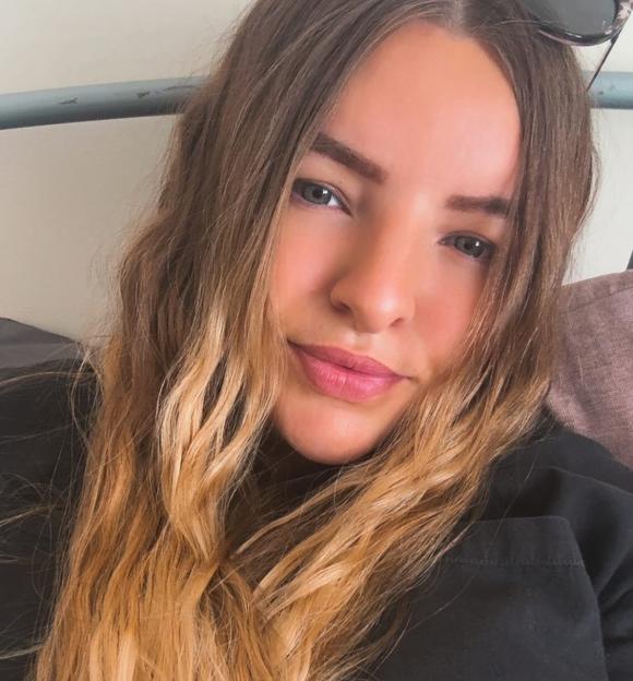 Chelsea Hammill, a woman with long, wavy blonde hair, looking directly at the camera.