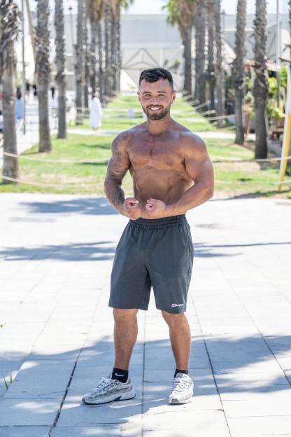 Tommo Holbrook flexing his biceps in Barcelona, Spain.