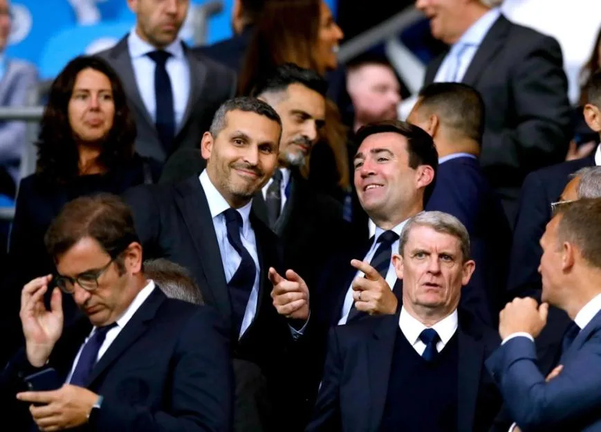 Manchester City Chairman Khaldoon Al Mubarak and Mayor of Manchester Andy Burnham sit in the stands at the Etihad Stadium.