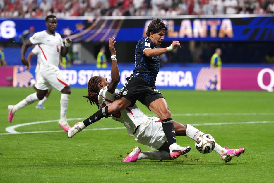 England's Djed Spence tackles Argentina's Giuliano Simeone during the FIFA World Cup 2026 semi-final match.