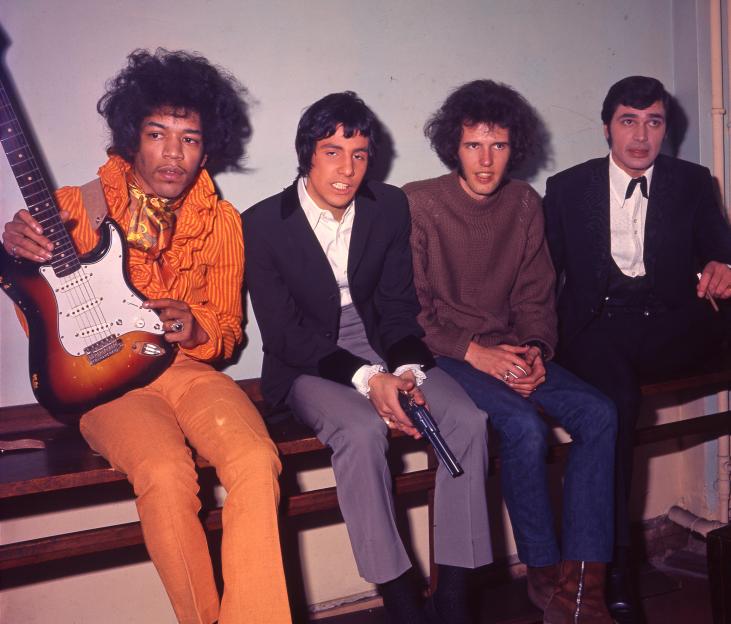 Jimi Hendrix backstage with Cat Stevens (holding a gun), Gary Leeds, and Engelbert Humperdinck.