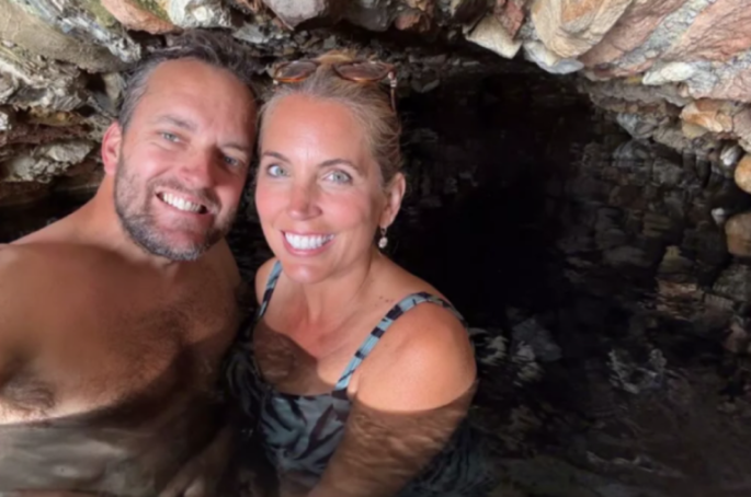 Jasmine Harman and husband Jon in a dark cave.