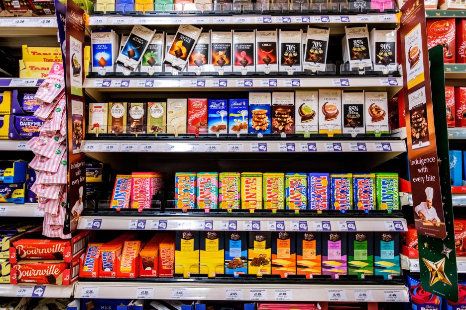 A selection of luxury chocolate brands for sale in a supermarket.