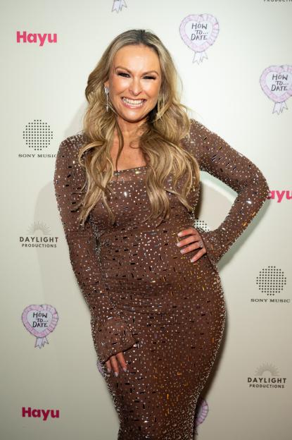 Mel Schilling smiling on the red carpet at the "How To Date" launch party event.
