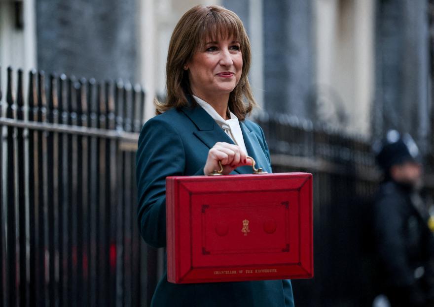 British Chancellor of the Exchequer Rachel Reeves posing with the red budget box outside her office in Downing Street.