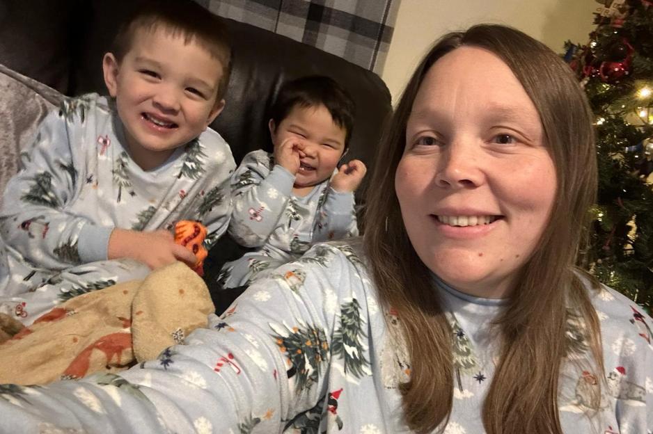 Becky Harris poses for a selfie with her two sons, Gray (3) and Jensen (6), while wearing matching Christmas-themed pajamas.