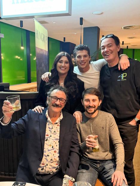 Five people, including Lewis Cope, Sophie Sandiford, and Pete Sandiford, pose for a photo at a dinner party.