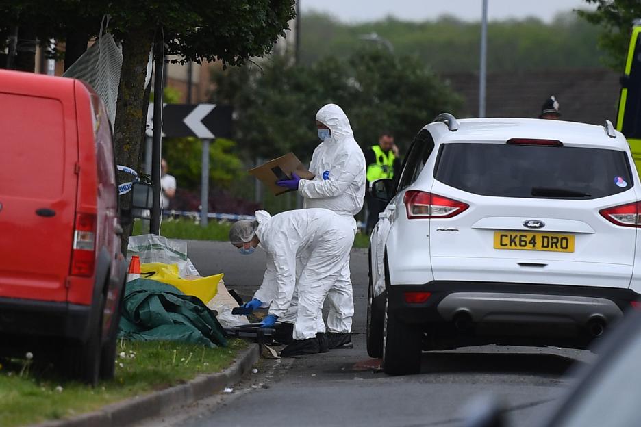 Forensic officers investigating a road traffic collision scene.