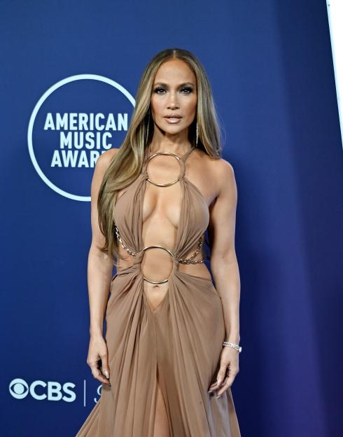 Jennifer Lopez in a beige cut-out dress with gold ring details at the American Music Awards.