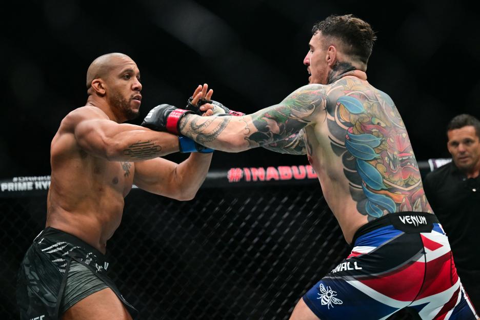Ciryl Gane (left) and Tom Aspinall (right) fight during their UFC heavyweight title bout.