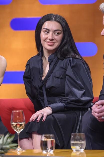 Charli XCX smiles during filming for the Graham Norton Show.