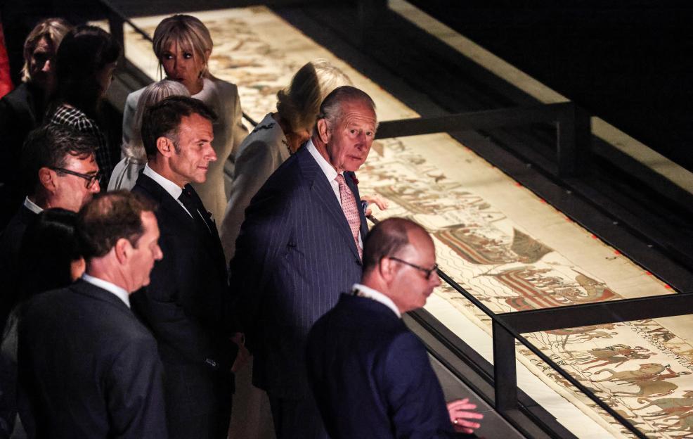 Britain's King Charles III, Queen Camilla, French President Emmanuel Macron, and Brigitte Macron view the Bayeux Tapestry.