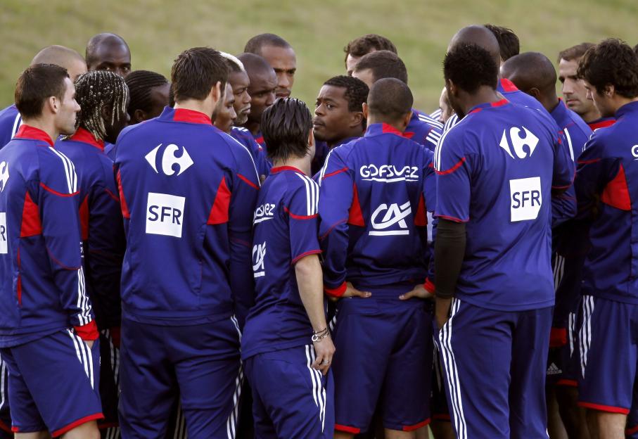 France's national soccer team players listen to their captain Patrice Evra before deciding not to take part in a training session in Knysna, near Cape Town