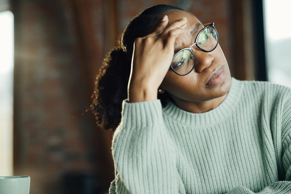 Young woman experiencing a headache.