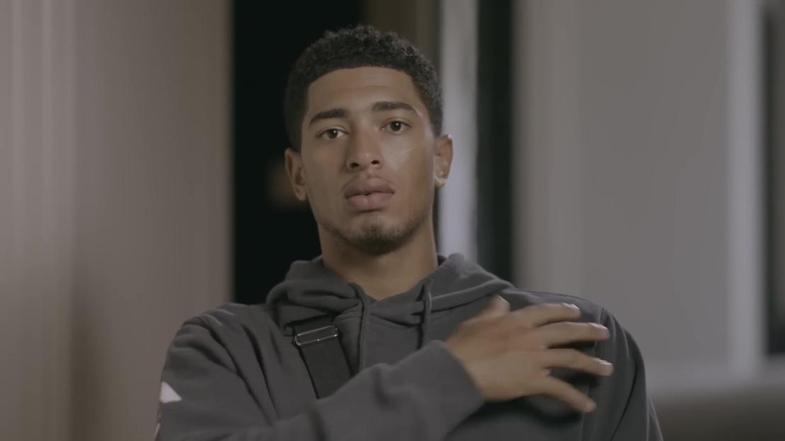 Jude Bellingham touching his shoulder, discussing his injury.