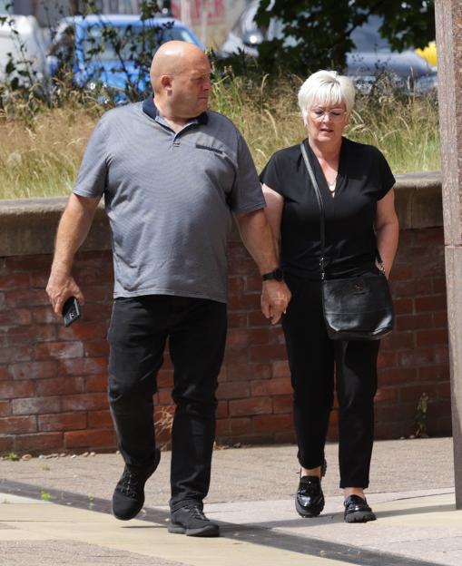 Lisa Farnsworth walking hand-in-hand with a man.