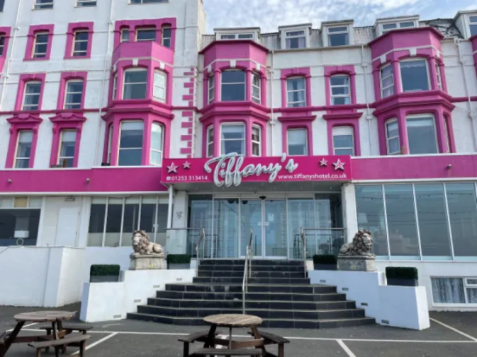 Tiffany's Hotel with a hot pink facade and bay windows.