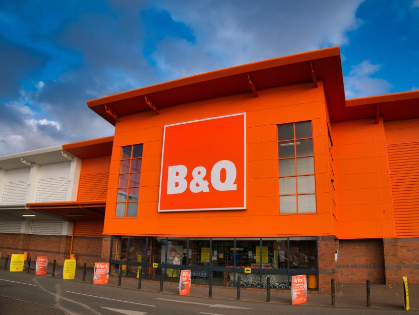 B&Q DIY store exterior with its orange facade, logo, and promotional signs.