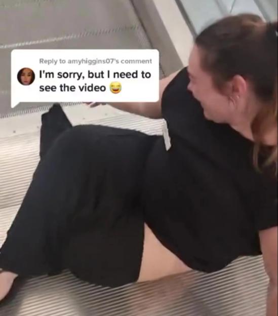 A woman in black clothing and bare legs sitting on an escalator with a text box overlay that reads "I'm sorry, but I need to see the video"