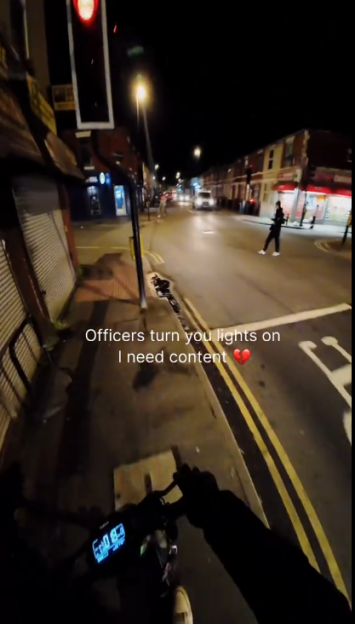 Point-of-view shot from an e-scooter at night with the text "Officers turn you lights on I need content" and a broken heart emoji.