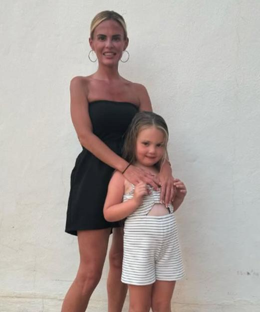 Kaylie Kelliher and her daughter Boe Bushnell standing against a white wall.