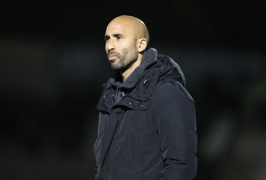 Huddersfield Town manager Lee Grant in a black coat looking left.