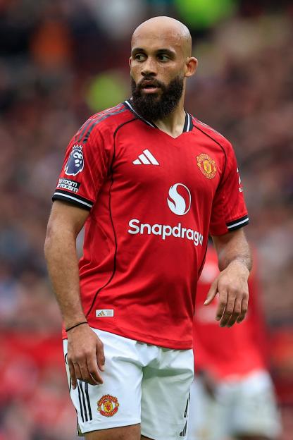 Manchester United player in a red jersey and white shorts.