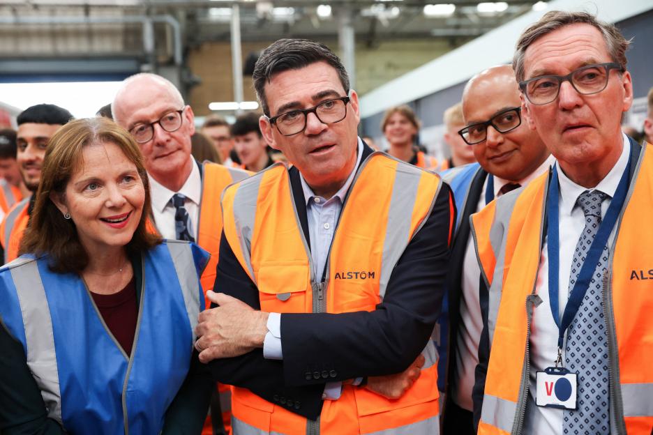 Prime Minister Andy Burnham (center) with Pat McFadden (second from left) and Alan Milburn (right) during a visit to Alstom Transport in Derby.