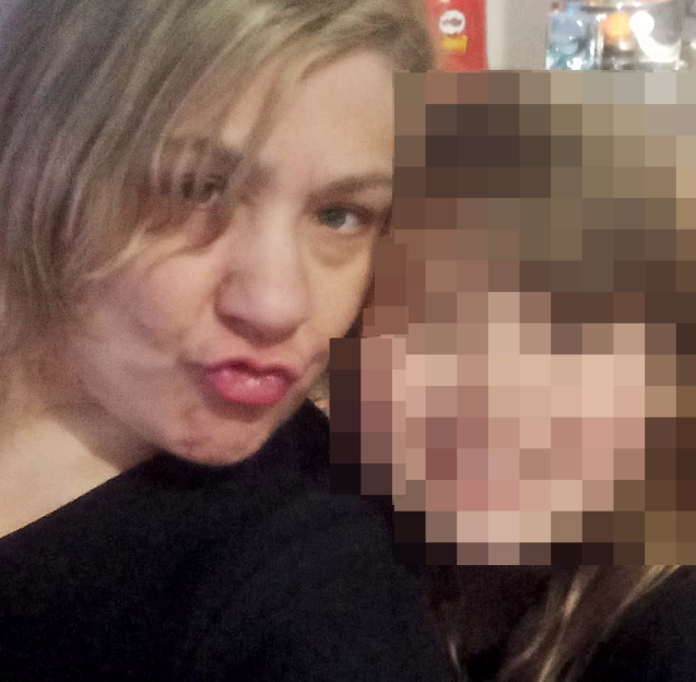 Sarah Forrester posing with a blurred person.