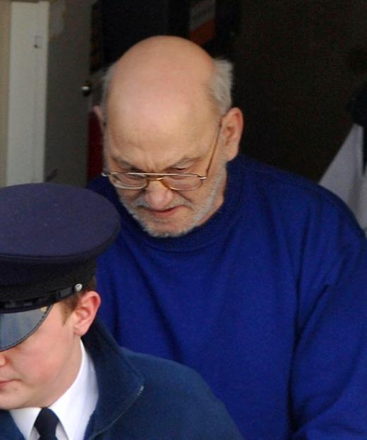 Robert Black, the suspected murderer of Jennifer Cardy, with a police officer.