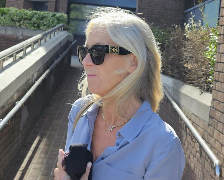 Sally-Anne Bowen walking outside while wearing sunglasses.