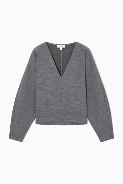 A grey COS V-neck boiled wool jumper.