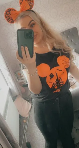 Jess Hulley-Jones taking a mirror selfie wearing a Halloween-themed Disney outfit.