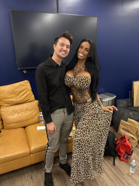 Jake Pankethman smiling next to Katie Price who is wearing a leopard print outfit.