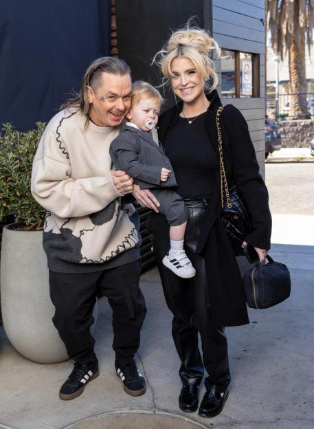 Sid Wilson and Kelly Osbourne holding their son Sidney Wilson.